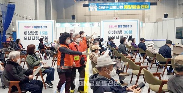 의용소방대원이 어르신에게 대기 자리를 안내하고 있다.(마포소방서 제공)
